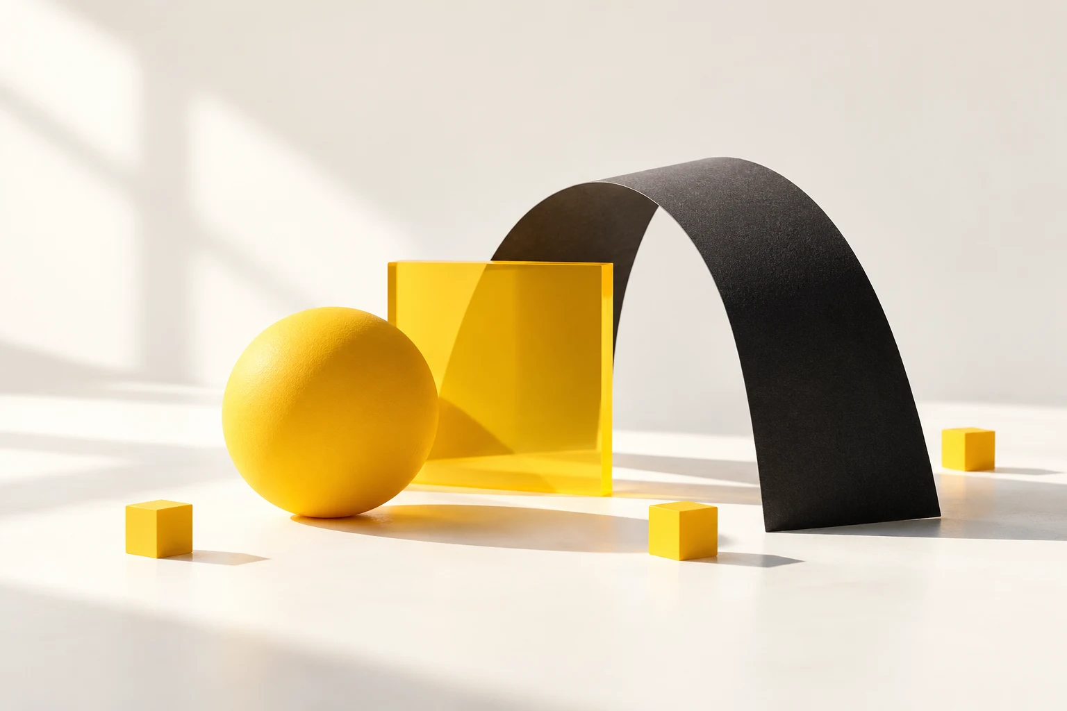 Sculptural yellow and black shapes on a white studio background